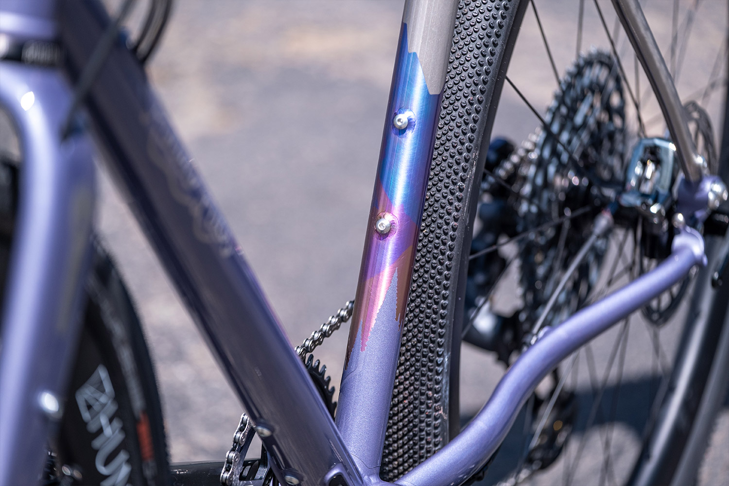 Multi color anodized titanium gravel bike. Dusty purple cerakote on bicycle. Flaanimal 5 Titanium bicycle by Rodeo Labs.