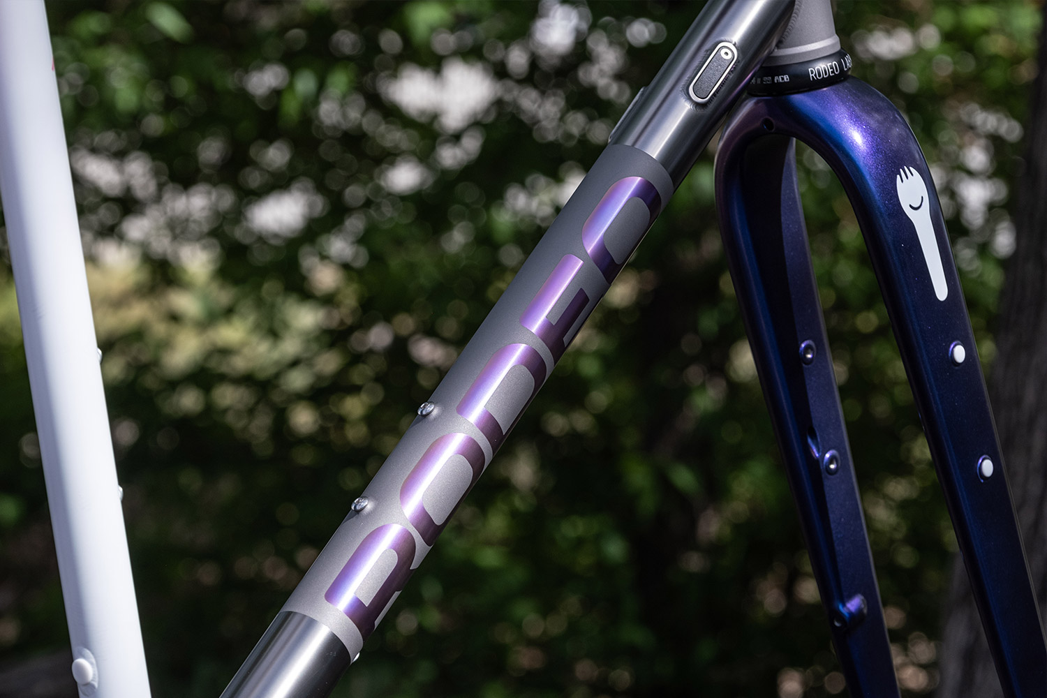 Light purple anodized titanium gravel bike. white cerakote and FX color shift blue on bicycle. Flaanimal 5 Titanium by Rodeo Labs.