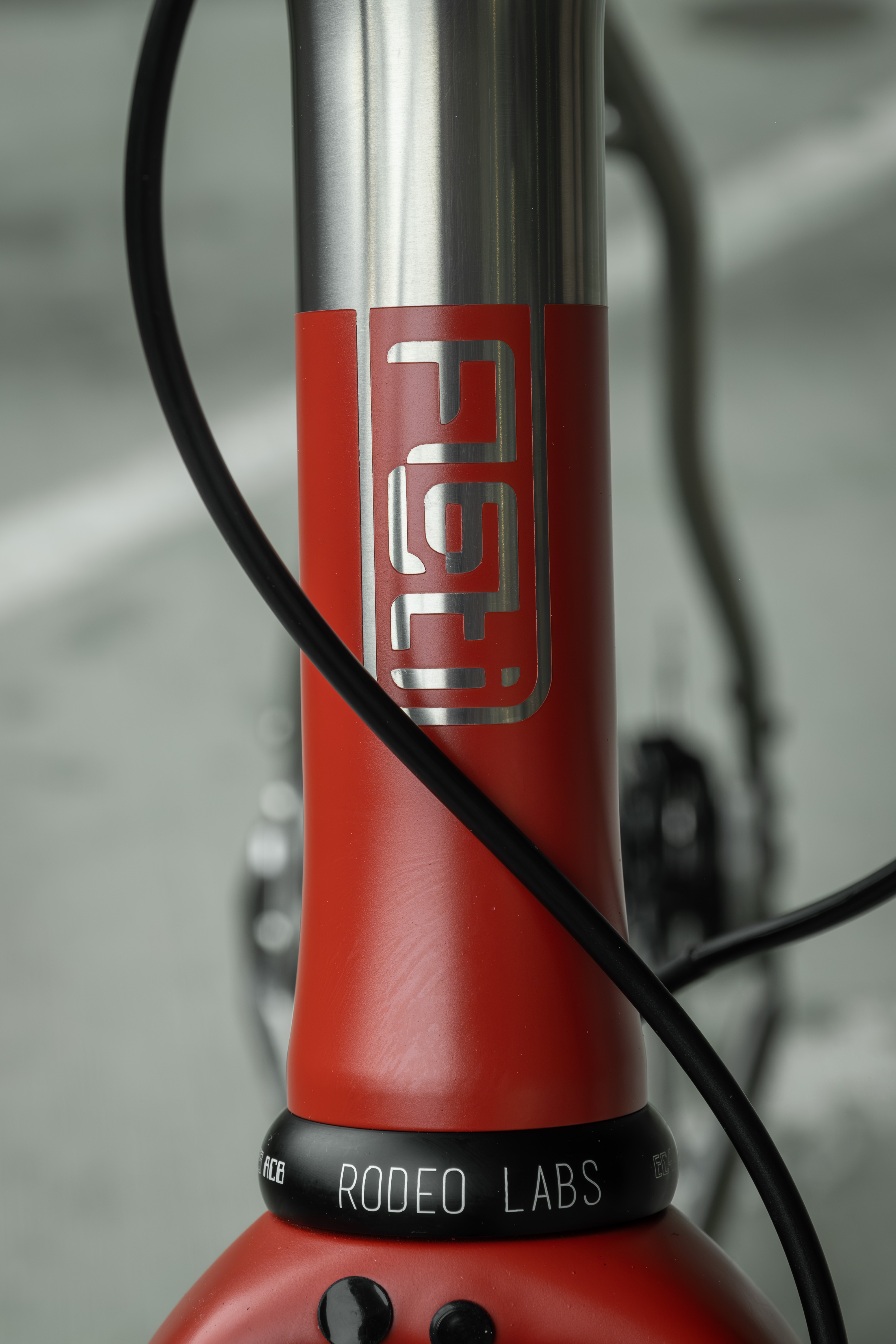 Close-up of a bicycle's head tube featuring a red design with 'Rodeo Labs' branding.