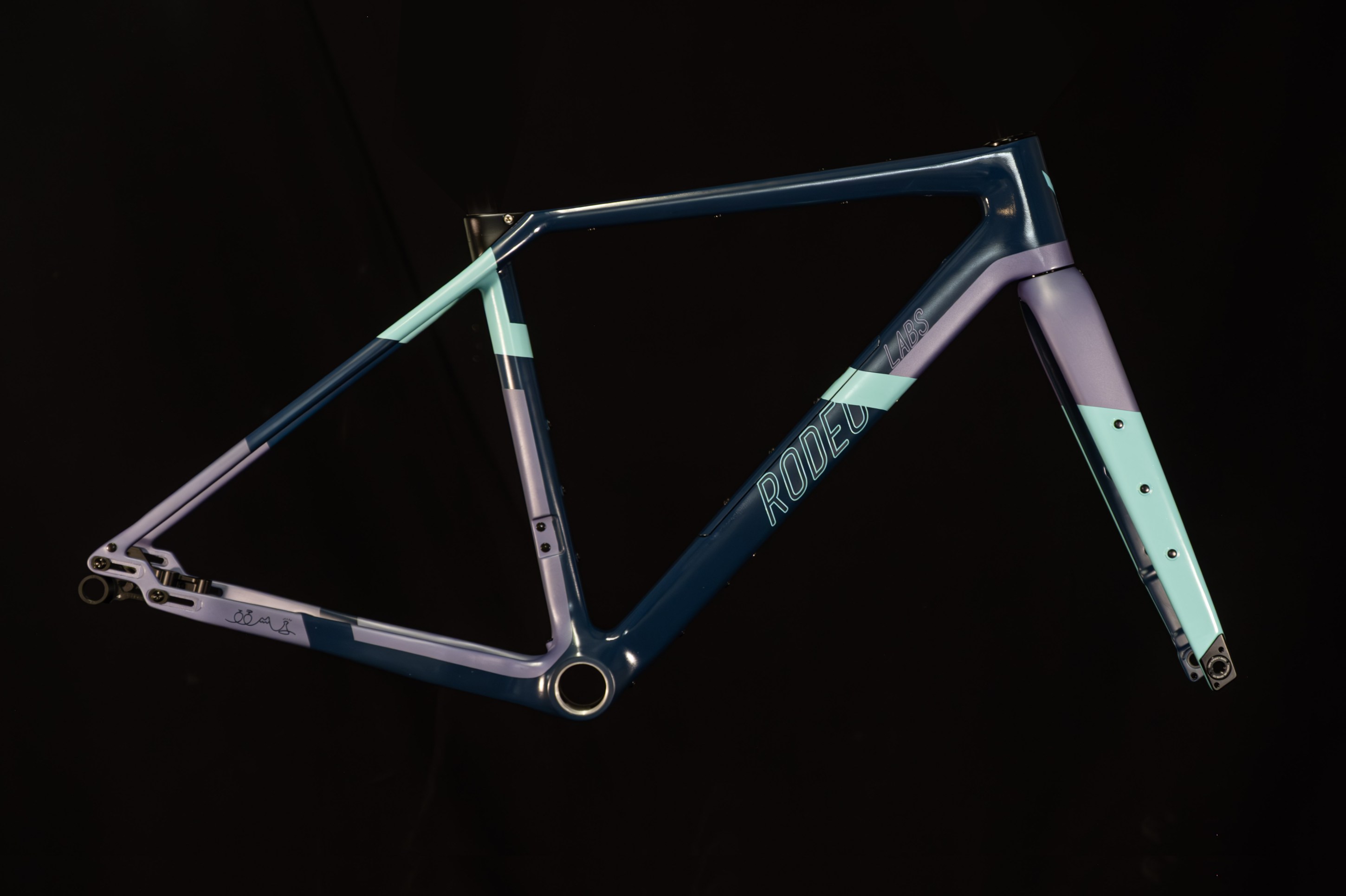 A colorful bicycle frame with a combination of dark blue, light blue, and purple colors on a black background.